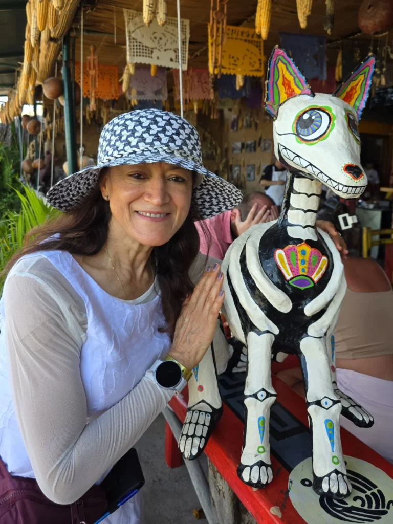 Local artisan with carved alebrije figurine