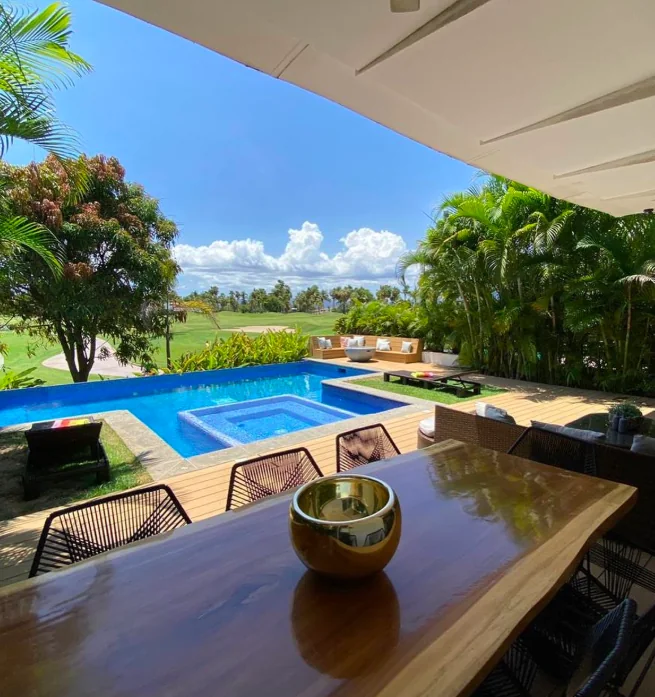 Covered dining terrace overlooking the pool and garden at Casa Palmar in El Tigre, Nuevo Nayarit.